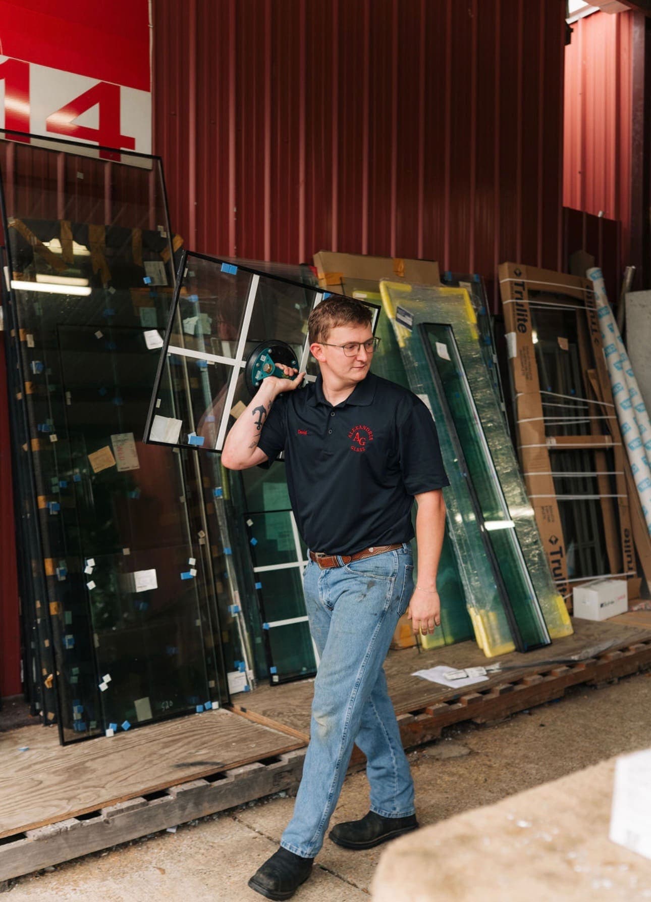 Crew member carrying a glass pane on his shoulder