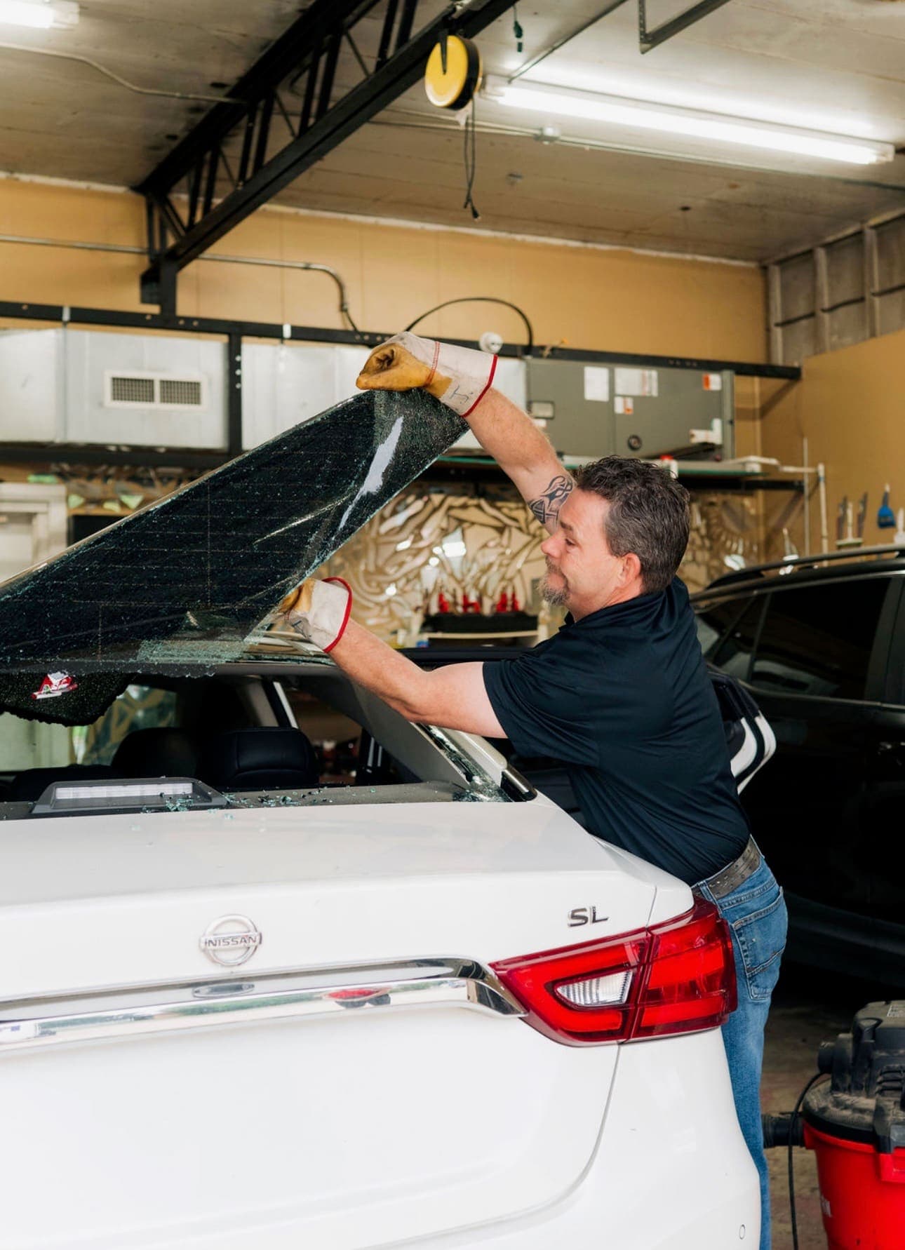 Tint film being squeegeed onto a side window