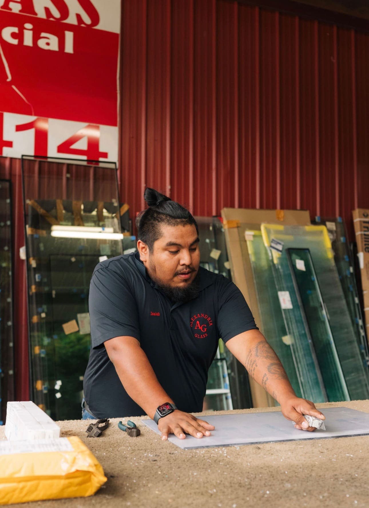 Glass being cut to size on the shop counter