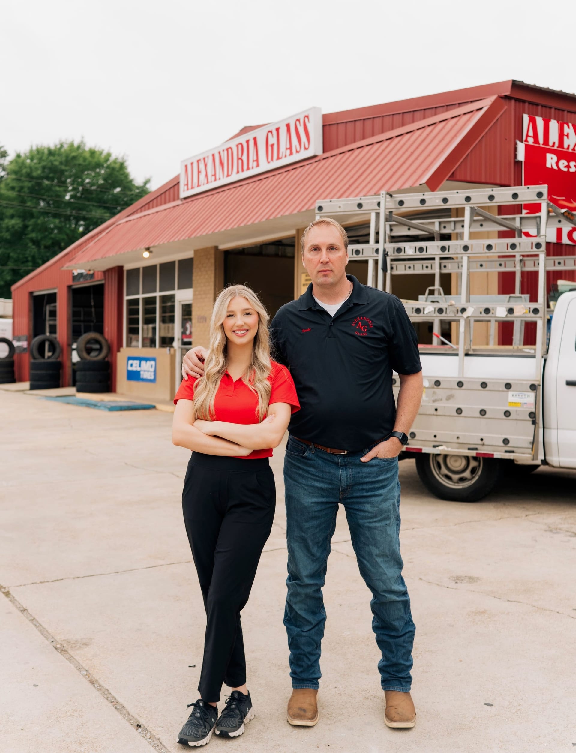 Randy Estes and his daughter Caroline standing in front of the Alexandria Glass storefront on Jackson Street