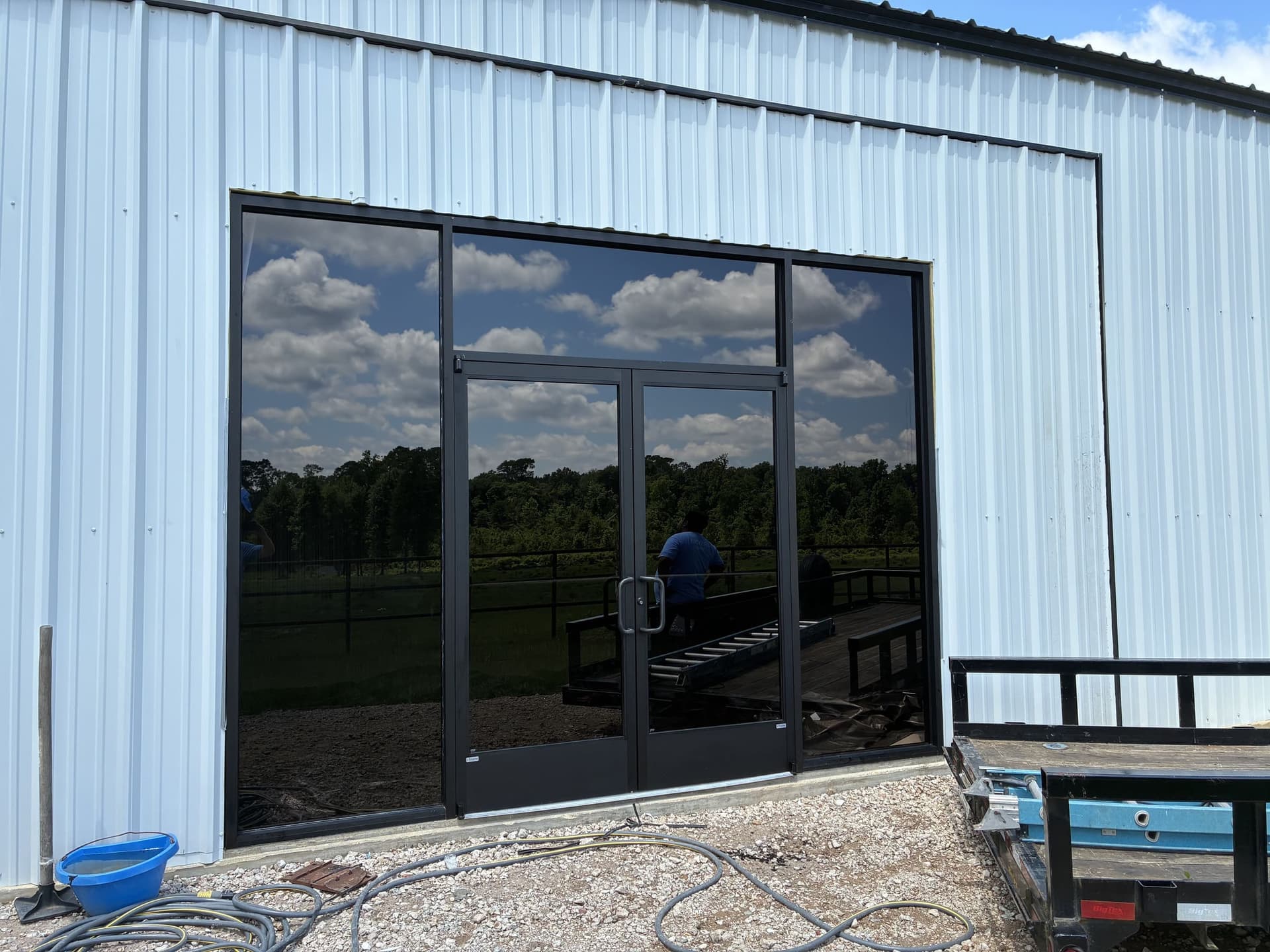 Black-framed glass storefront installed on a metal building